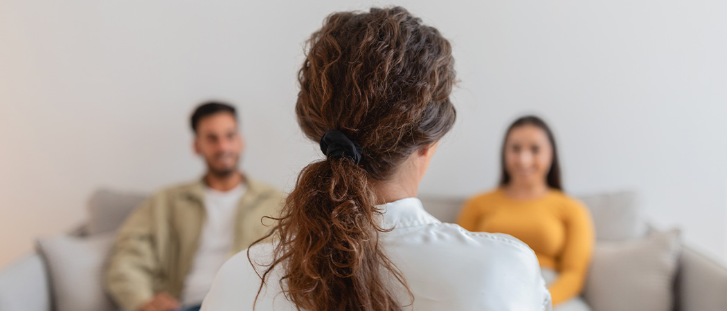 Couple talking with a therapist during a counseling session to rebuild relationship and communication