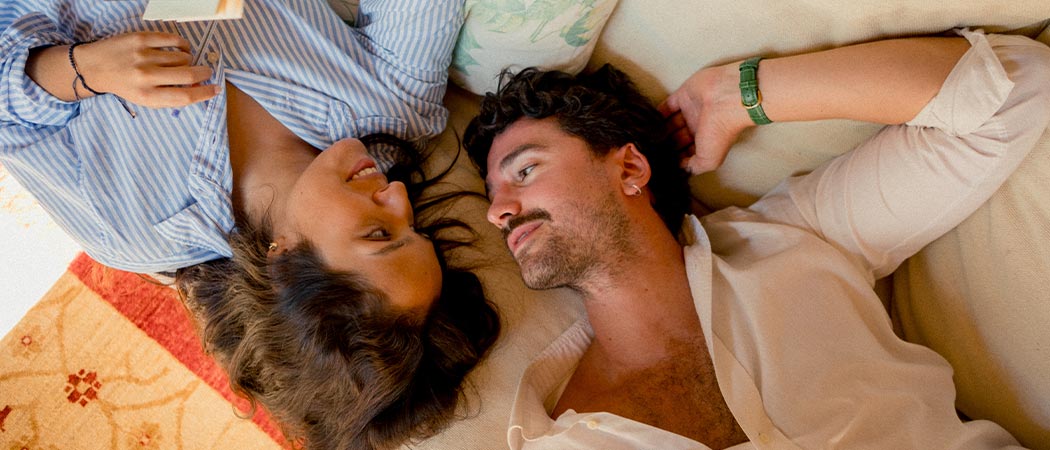 Couple holding hands in a calm, cozy setting